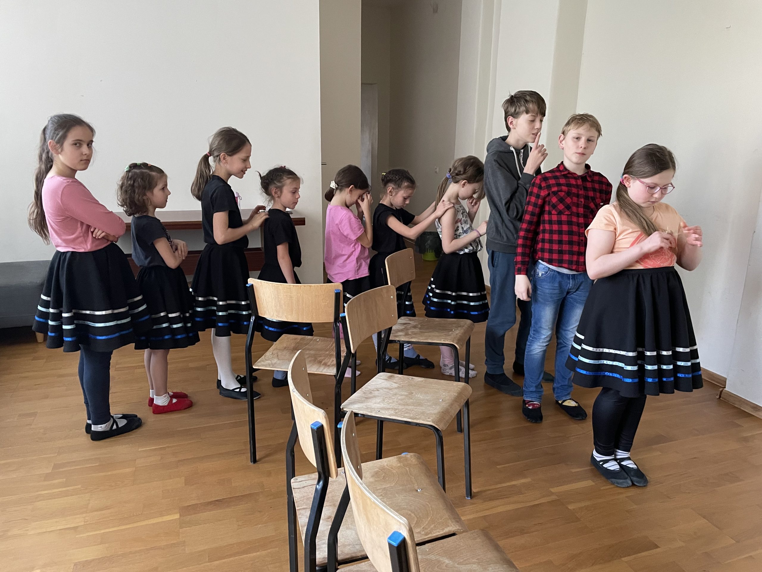 Zdjęcie z sali przedstawiające młodzież w trakcie zajęć wokalnych w akompaniamencie pianina elektrycznego